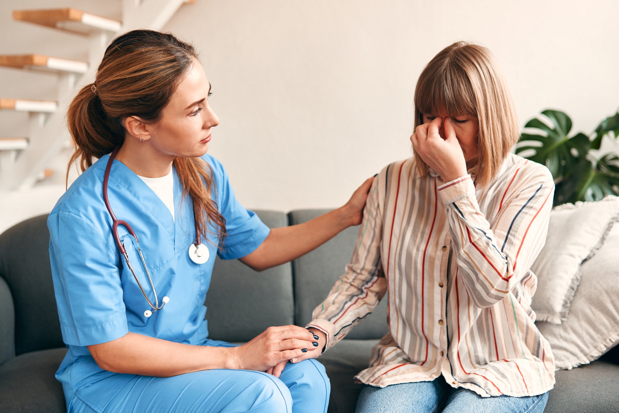 Family doctor came to the patient's home end of life care giver comforting family and exhibiting that care givers do more than treat symptoms